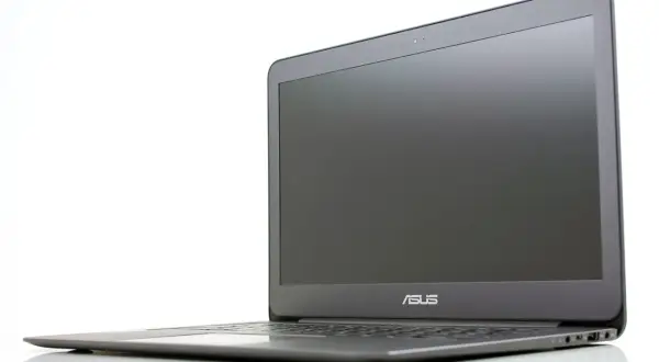 En stilren Asus Zenbook UX305 laptop i grått, med skärmen öppen och logotypen synlig.